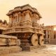 Stone chariot in courtyard of Vittala Temple at sunset in Hampi, Karnataka, India